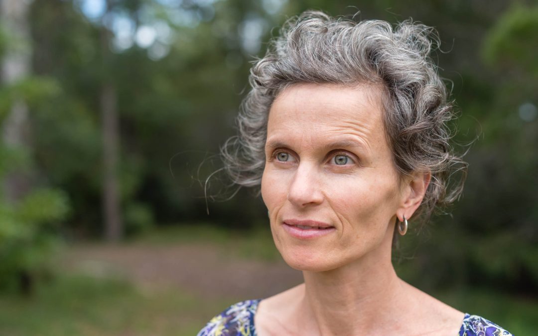 Older woman looking blankly into the distance.