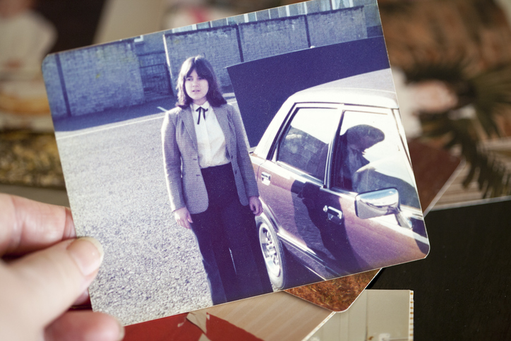 1970’s Photos Old photograph held in hand while reminiscing